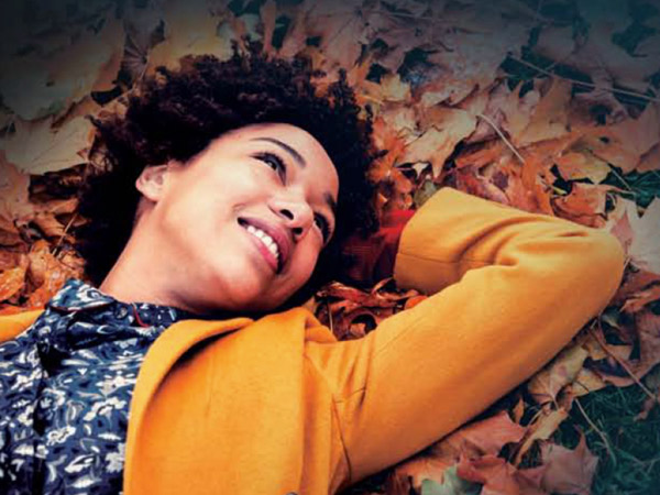 girl laying in leaves